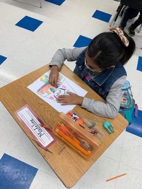 Student coloring at desk